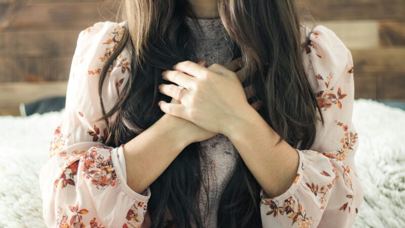 woman in white and red floral long sleeve shirt