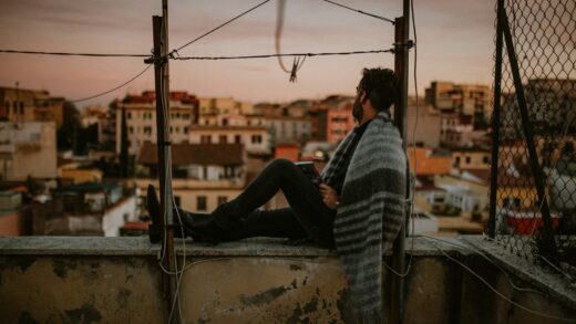 man in black and white stripe long sleeve shirt and black pants sitting on boat during